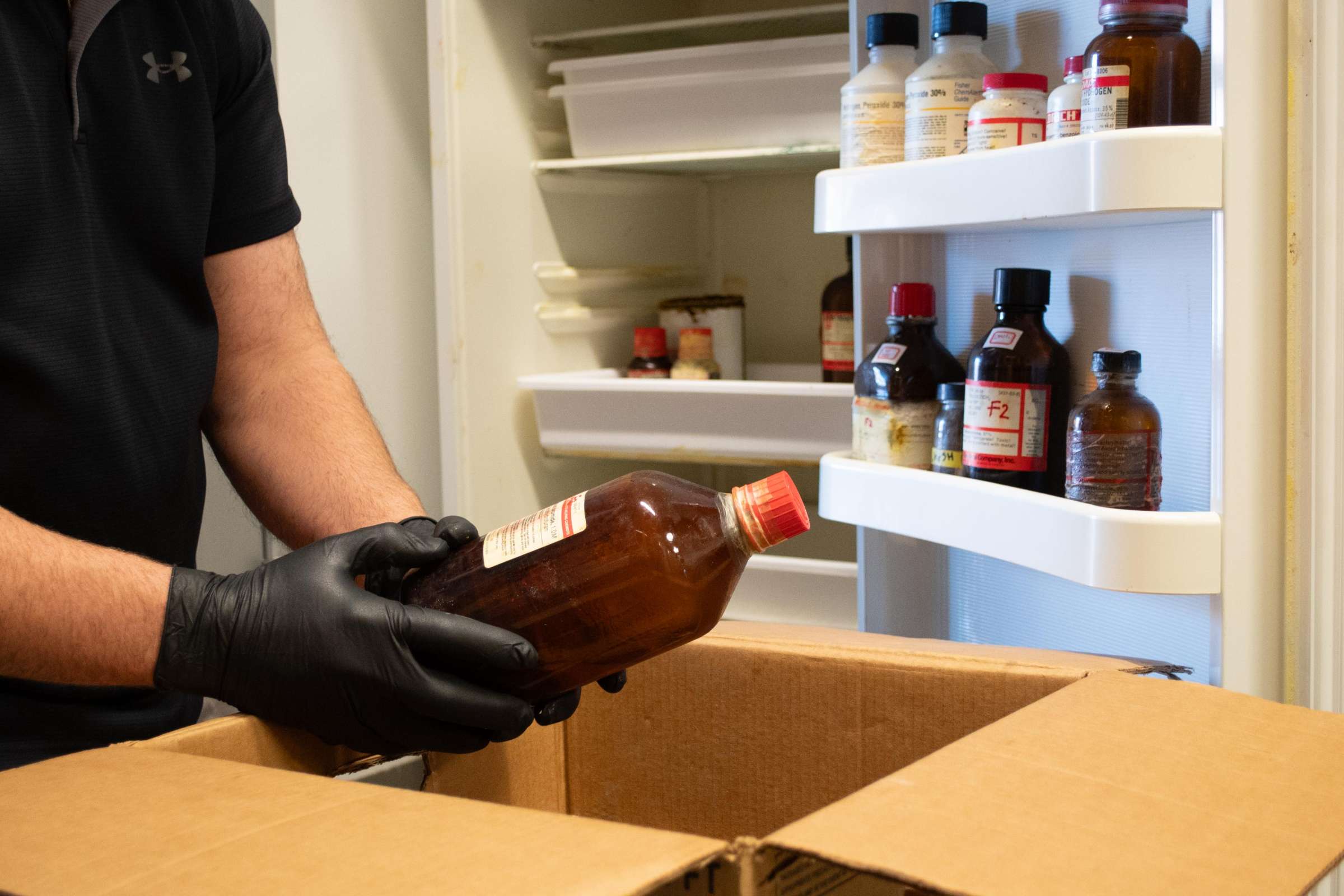 EH&S Environmental Program employee sorts chemicals during a laboratory cleanout